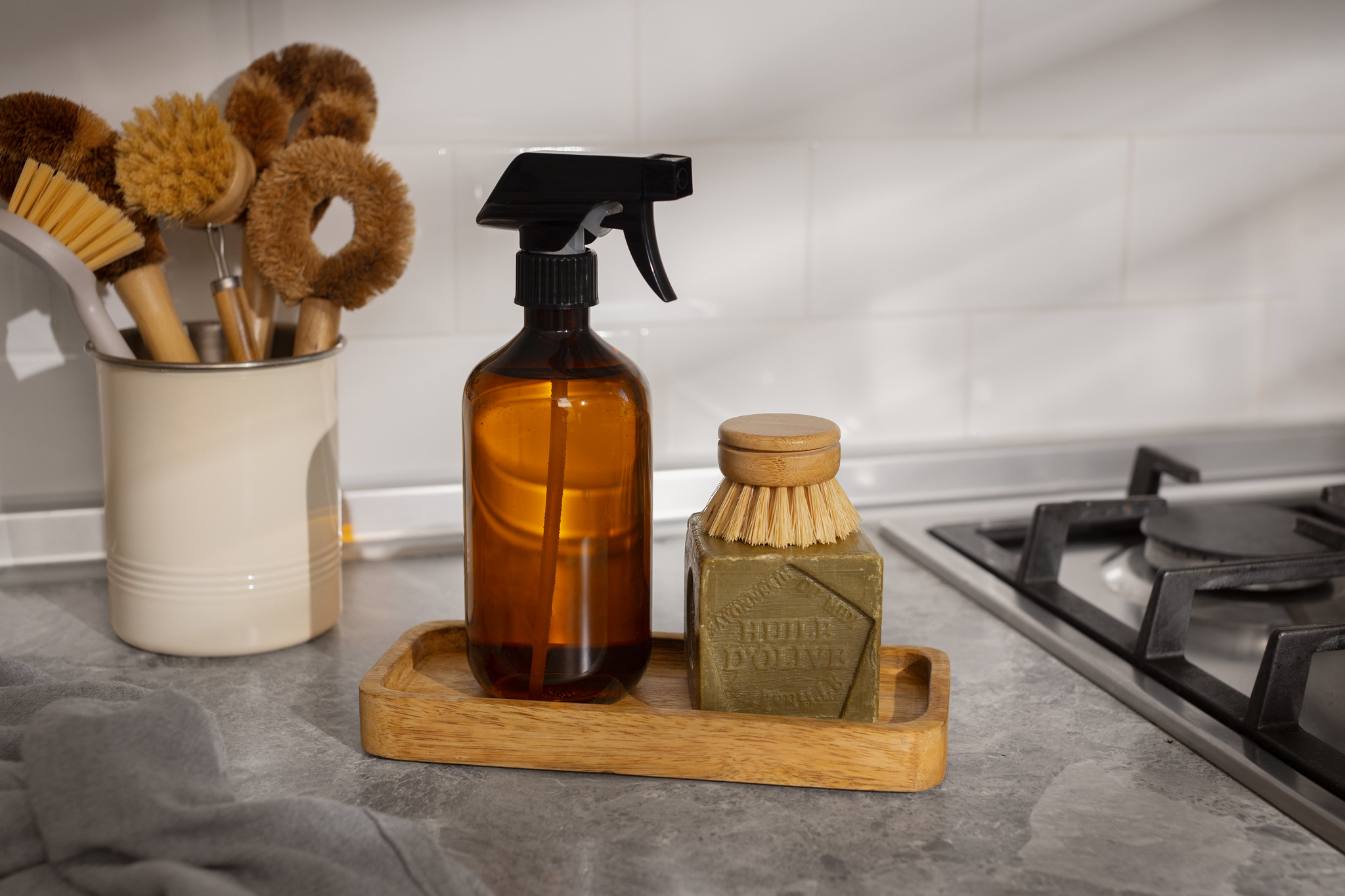 Simple kitchen cleaning supplies including soap, brush and spray bottle used for everyday food-safe cleaning
